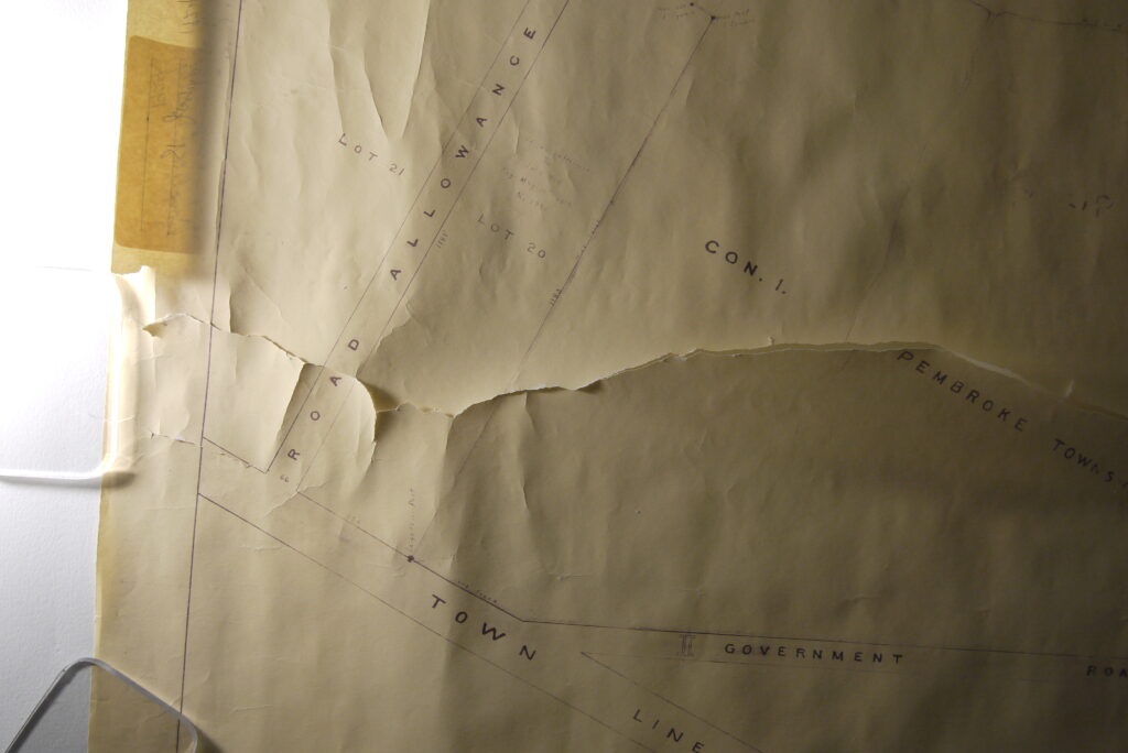 Detail of rolled and torn map before conservation treatment