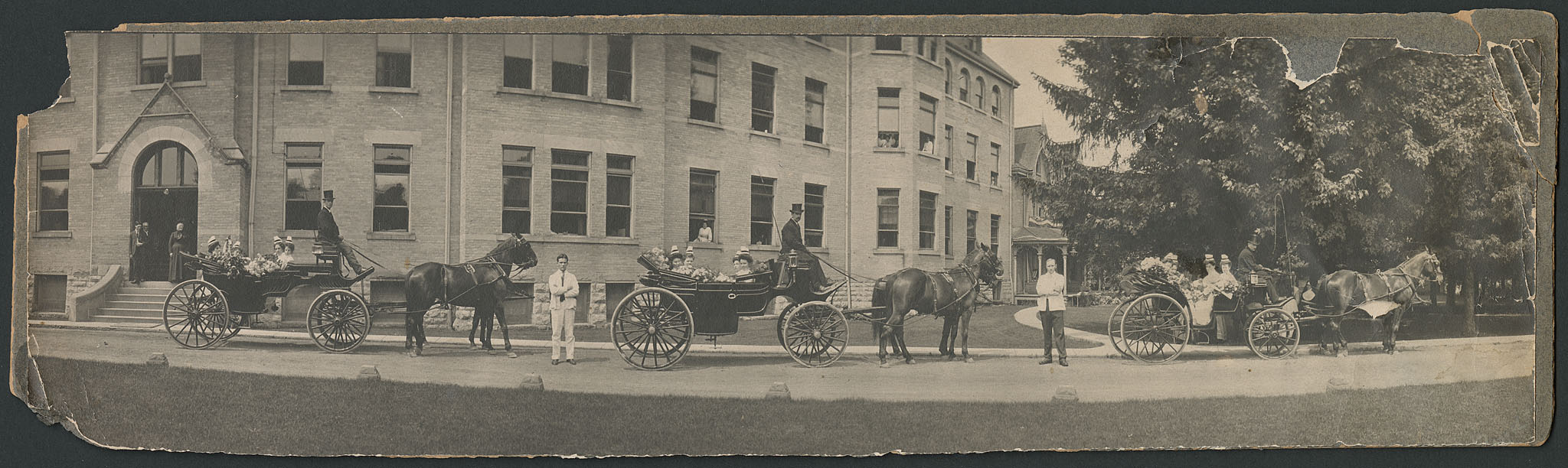 St. Joseph's School of Nursing graduation procession in front of the 1892 building at St. Joseph's Hospital, London, Ontario. Written on the back of the photograph is "P. Procession Aug/28" and a label dates it to approximately 1909.